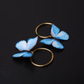 orecchini a cerchio con farfalle blu
