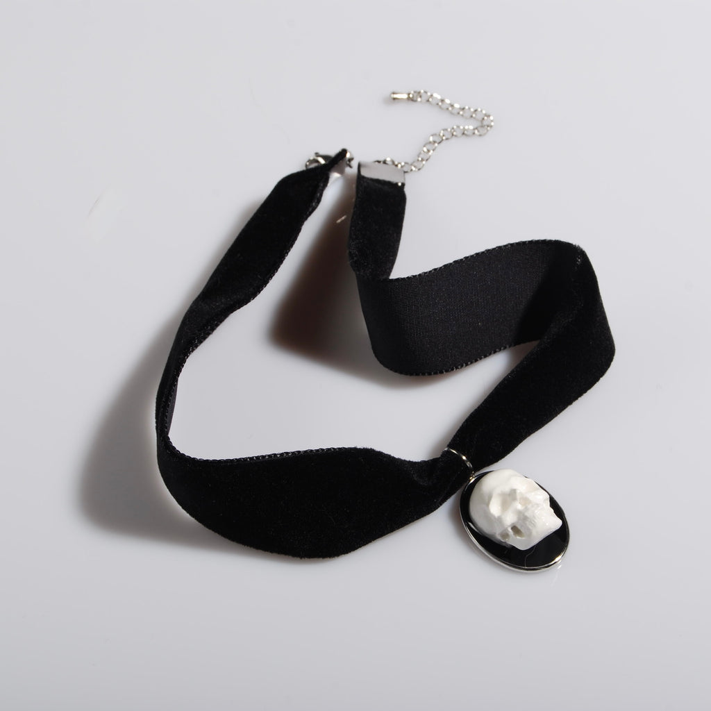 choker in velluto nero con pendente ovale con teschio stile cammeo, visto dall'alto