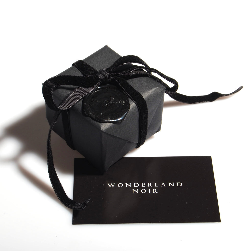 confezione regalo nera con nastro in velluto nero e sigillo in ceralacca con logo e bigliettino da visita