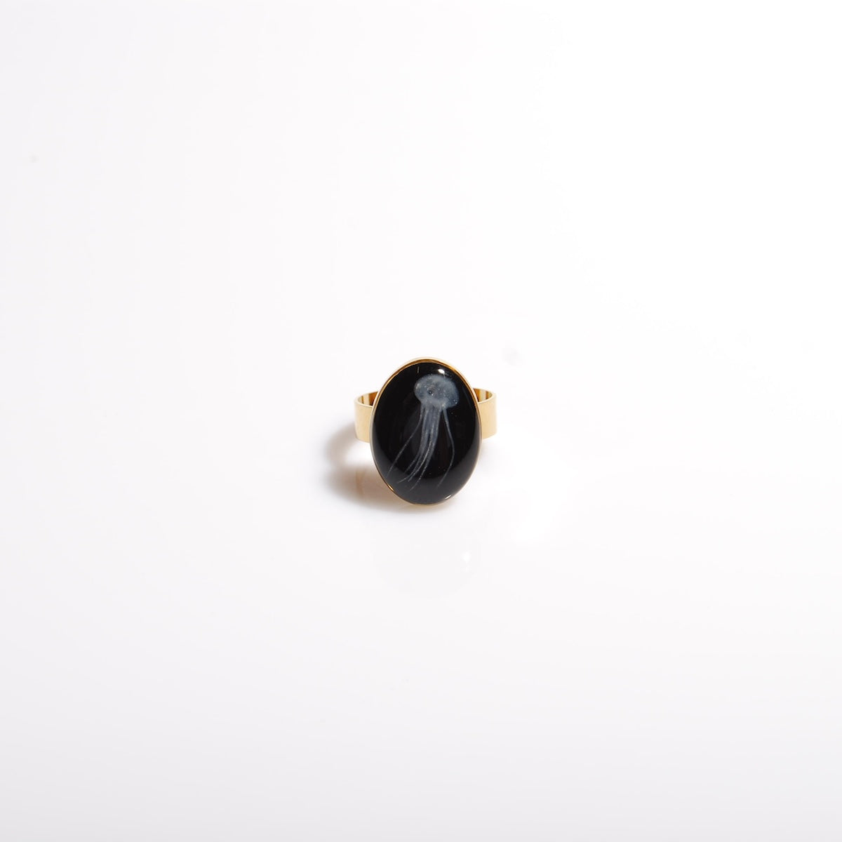 anello ovale con micro medusa marina inglobata sotto resina, vista frontale