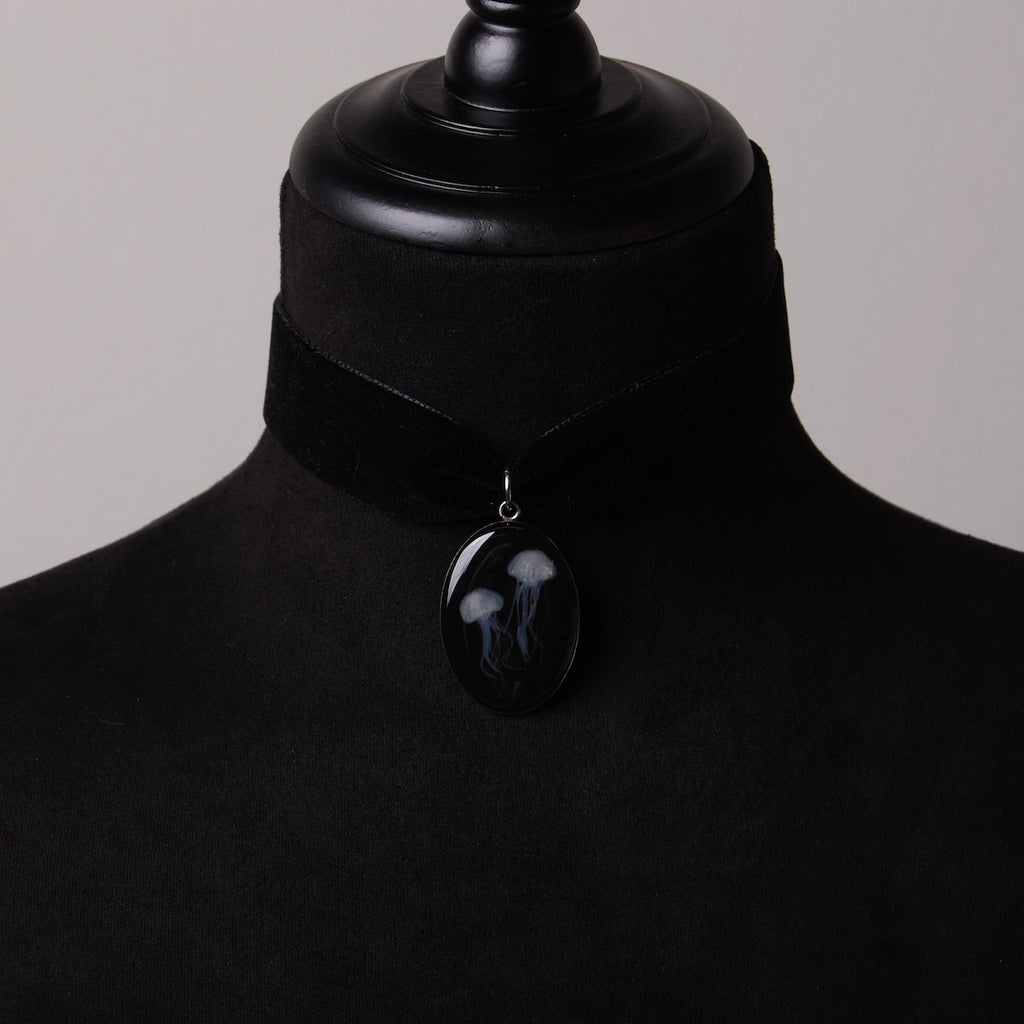 choker in velluto nero con pendente ovale con meduse marine su busto espositivo