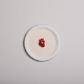 quadretto rotondo con cornice bianca e cuore anatomico rosso